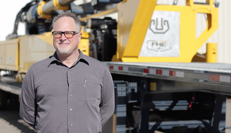 Matthew Kibler in front of FHE machinery